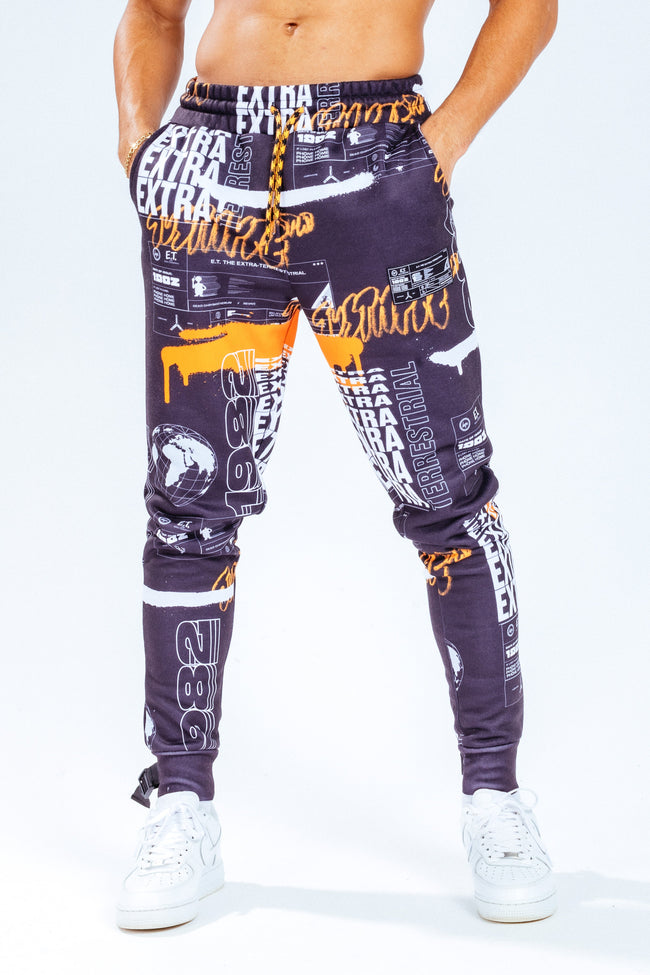 HYPE X E.T ORANGE AND BLACK REPEAT LOGO PRINT ADULT JOGGERS