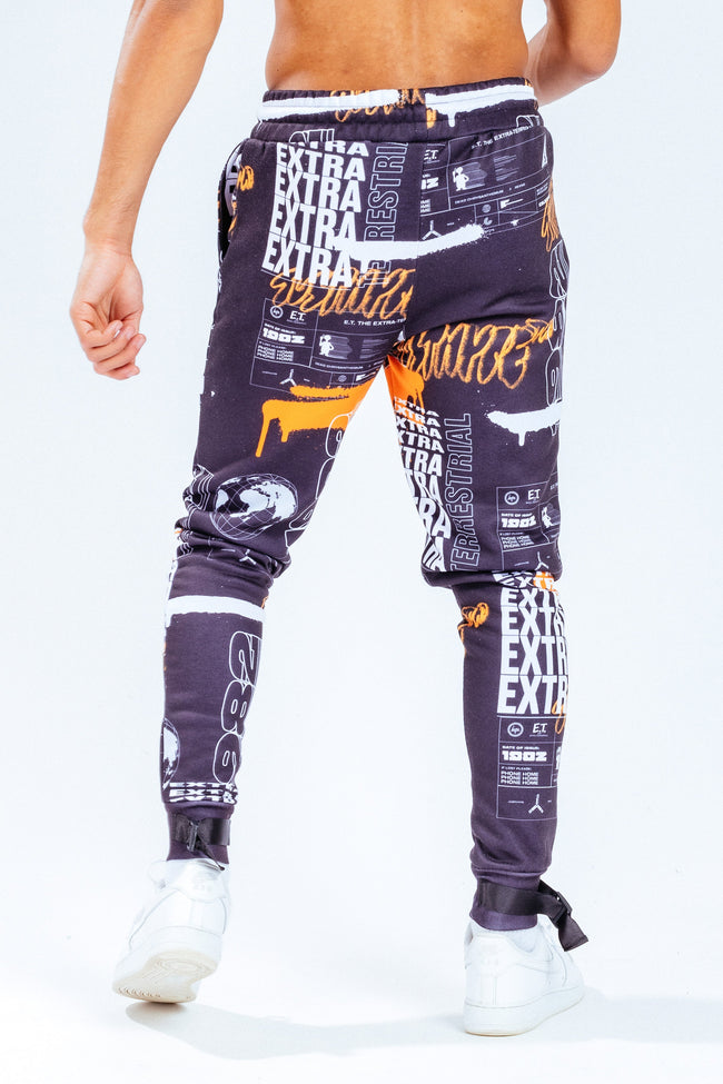 HYPE X E.T ORANGE AND BLACK REPEAT LOGO PRINT ADULT JOGGERS